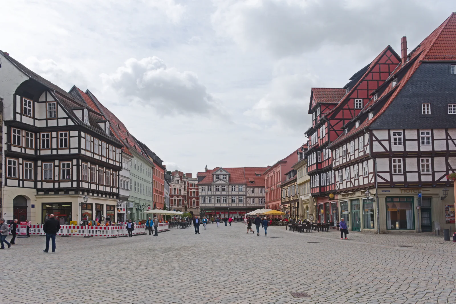 A broad cobbled market square framed by tall timber houses and red tiled roofs.